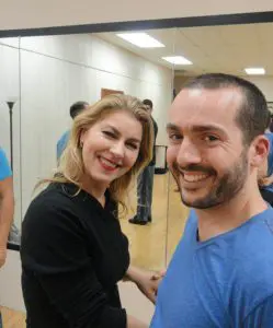 man and woman smiling and dancing during Bachata class