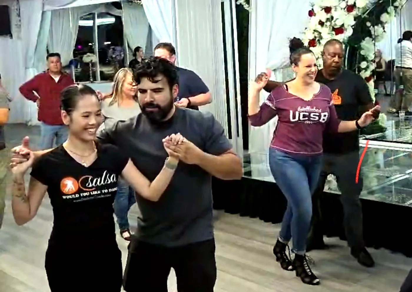 Students practicing partner dancing together at OC Salsa